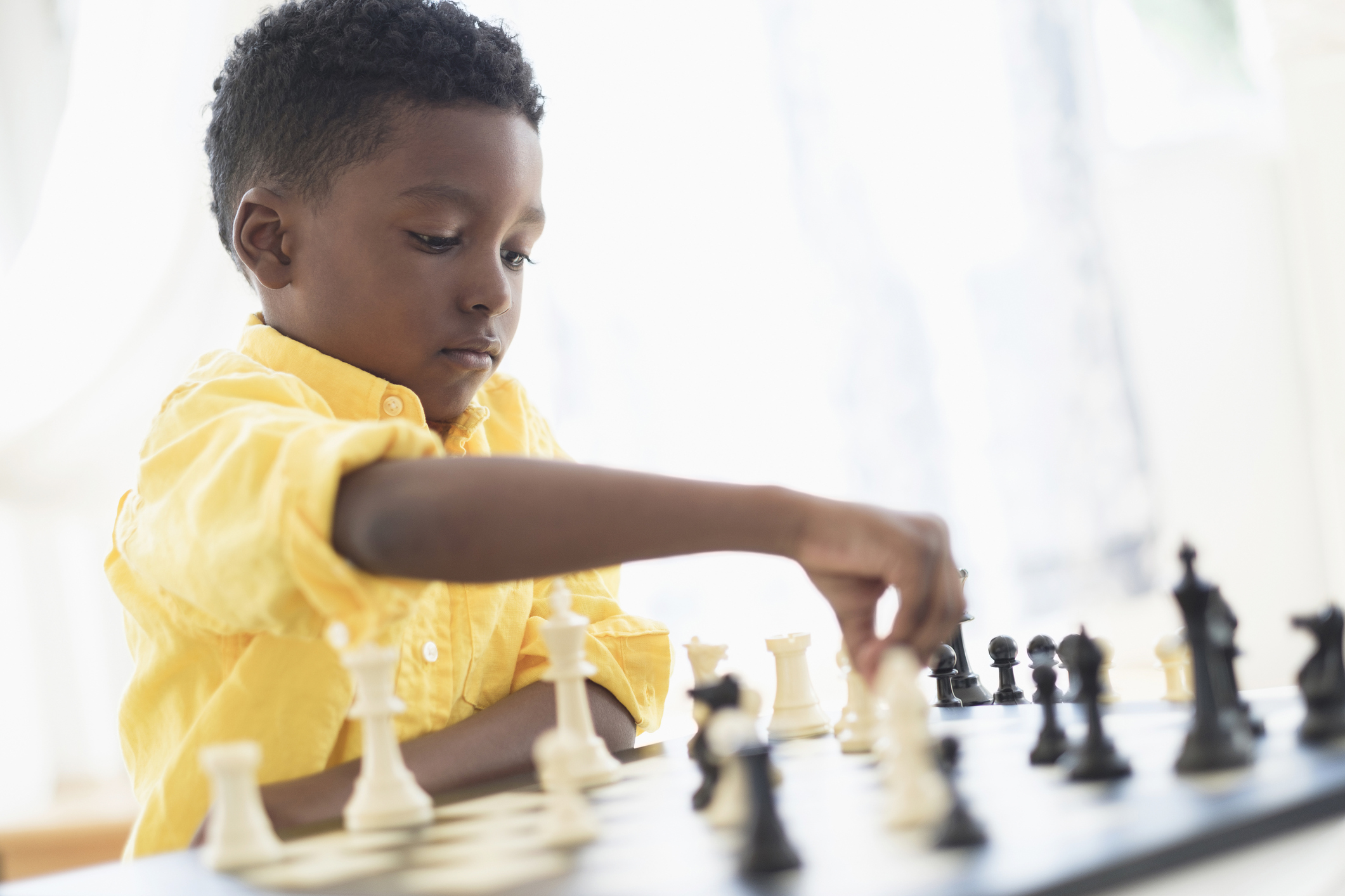 Boy (6-7) playing chess