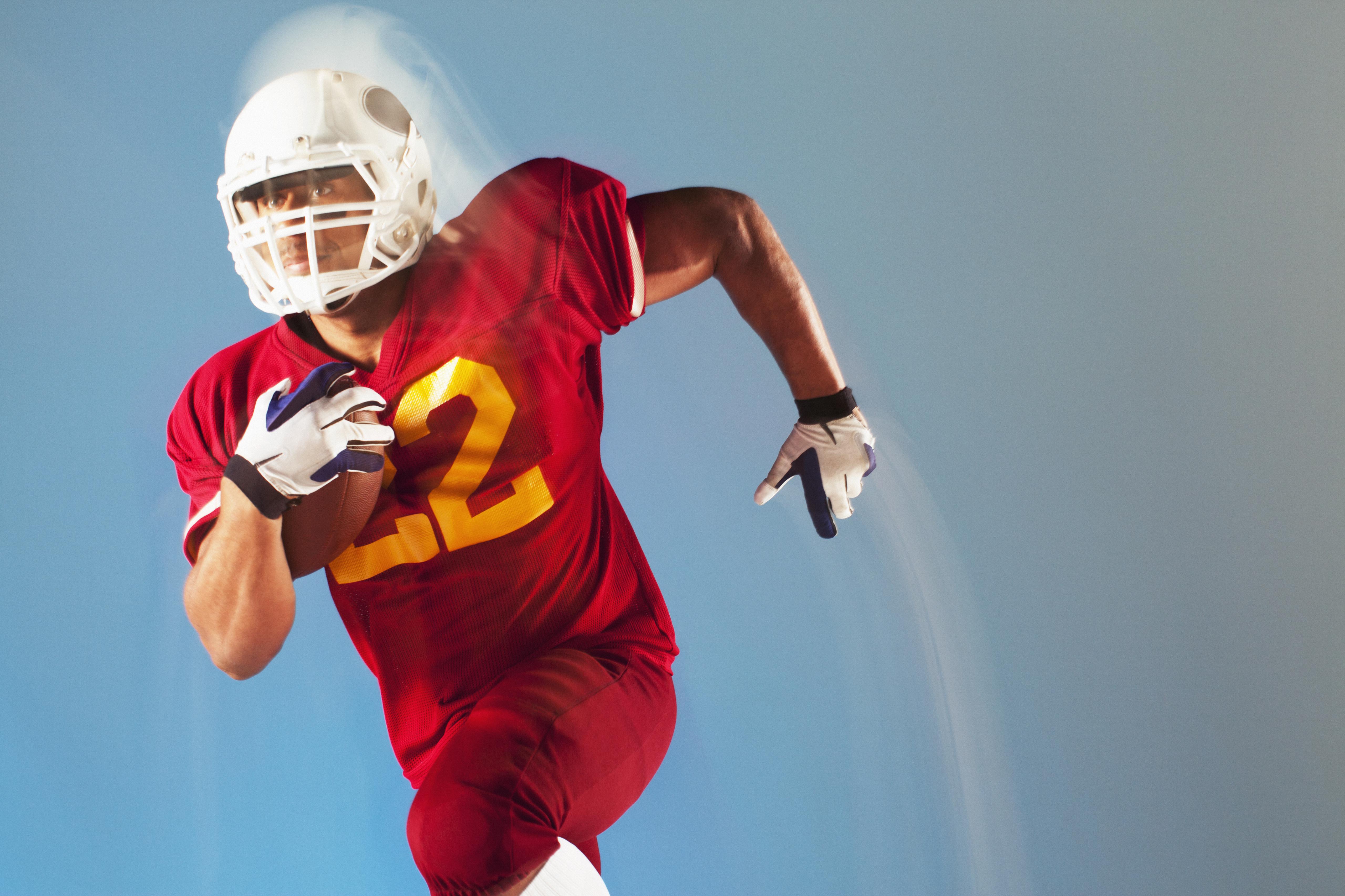Blurred view of football player running with ball