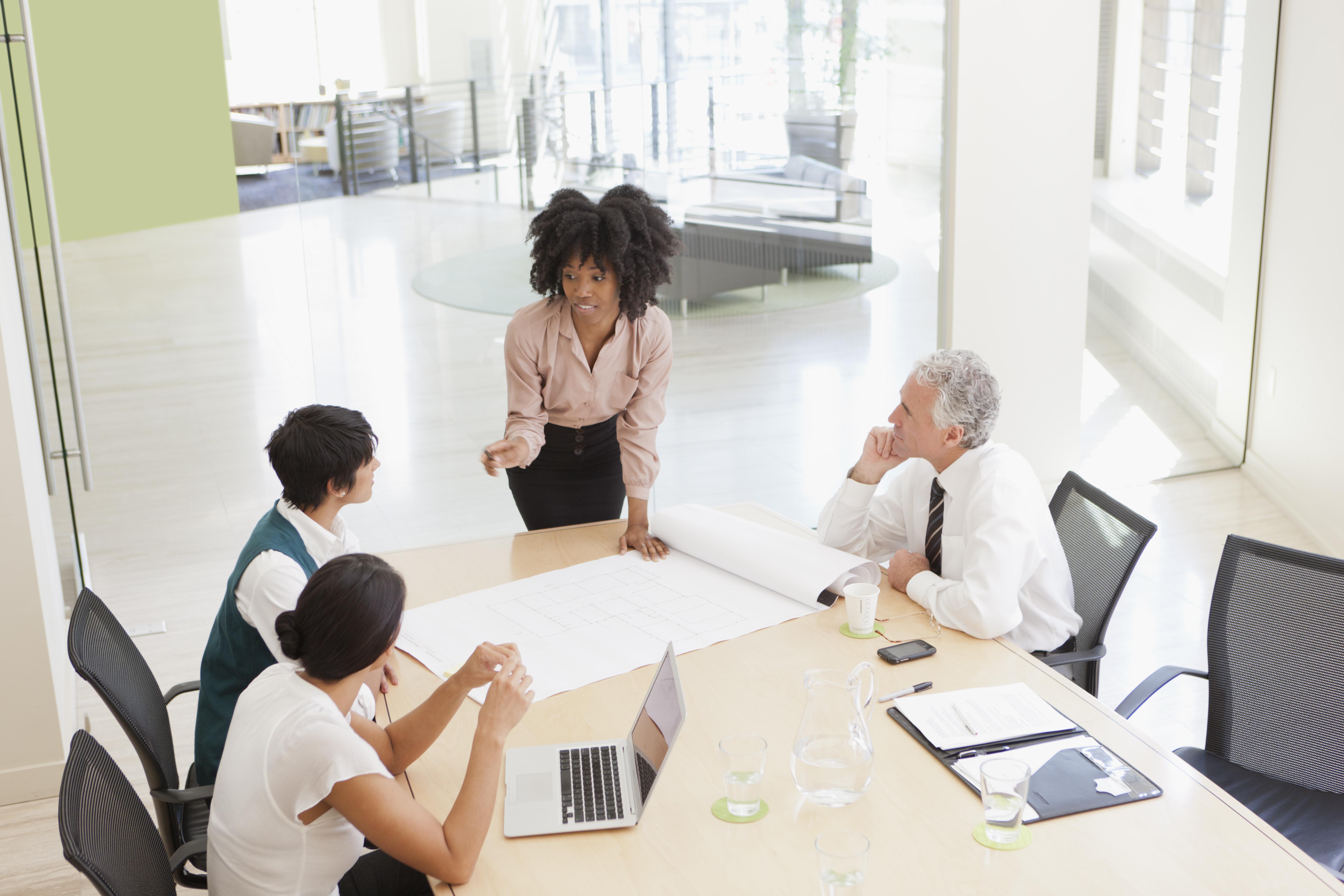 Project discussions amongst employees in boardroom