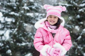 Girl playing in snow outdoors