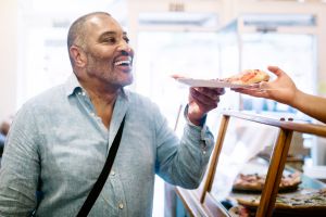 Mature Man Ordering Pizza Slice