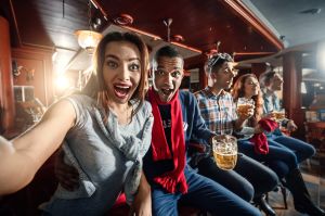 Fans at the bar make selfie on the bar