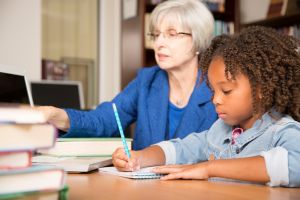 Elementary-age child learns computer coding in school.