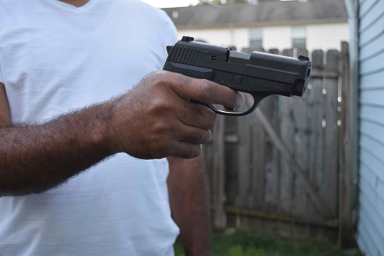 Man holding handgun pistol
