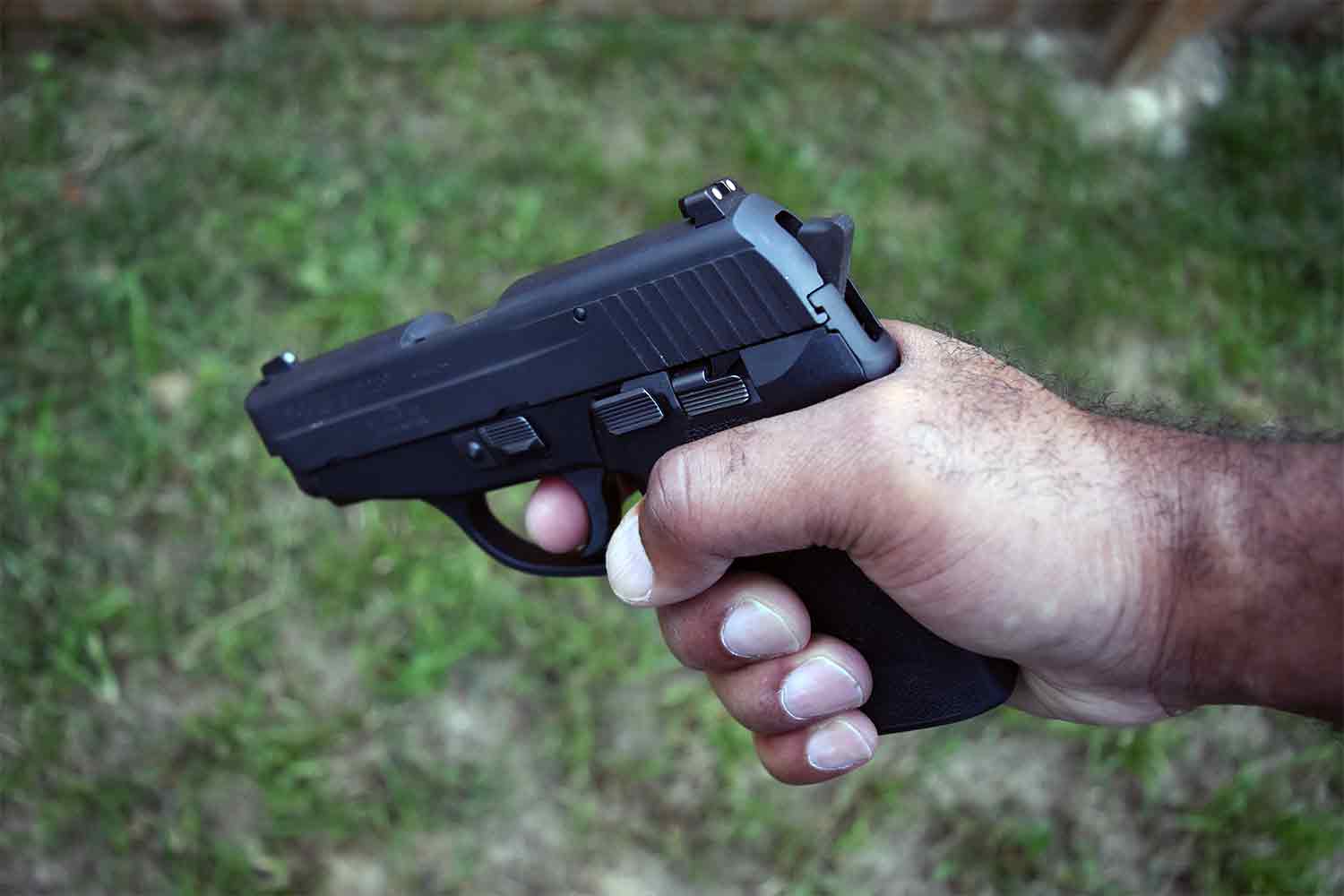 Man holding handgun pistol