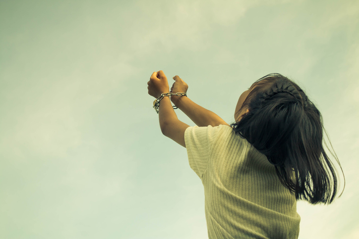 Girl Handcuffs Against Cloudy Sky
